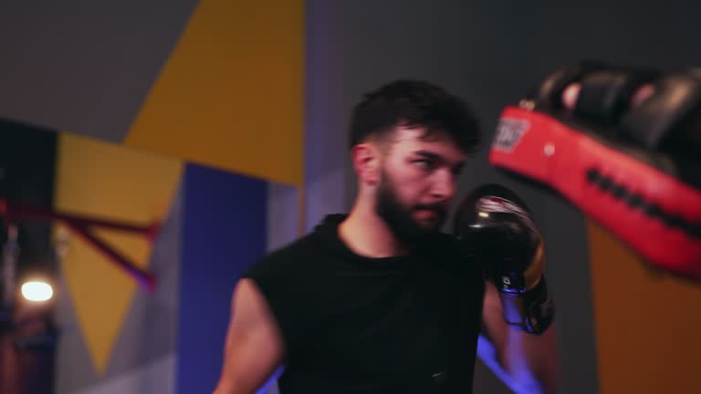 Young man punching training on punching pads.