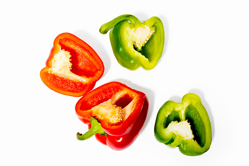 Multicolored Paprika on the white background. Cut out. Cross section of pepper with seeds.