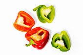 Vivid multicolored Paprika against white background. Cross section of pepper with seeds.