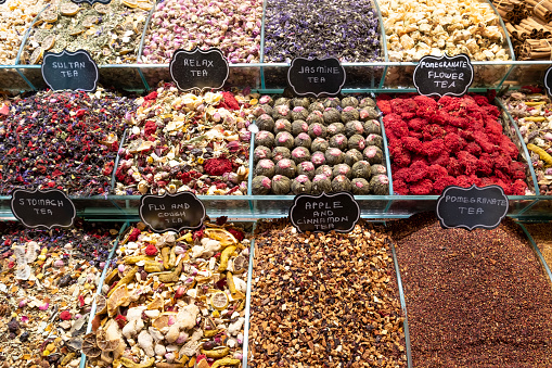 displays with different kinds of tea in a typical turkish store in the Spice bazaar or Egyptian bazaar in Istanbul, herbalist, herbal tea store, infusion mixture herbal floral fruit tea, horizontal