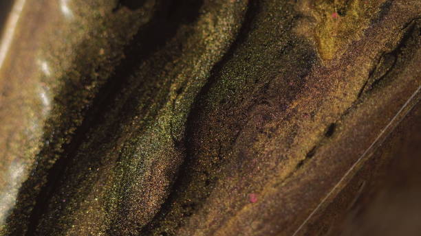 istock Glitter fluid texture paint spill golden black ink 2092494904