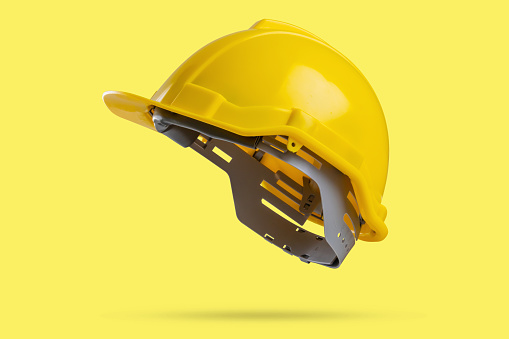 Safety construction helmet on yellow background