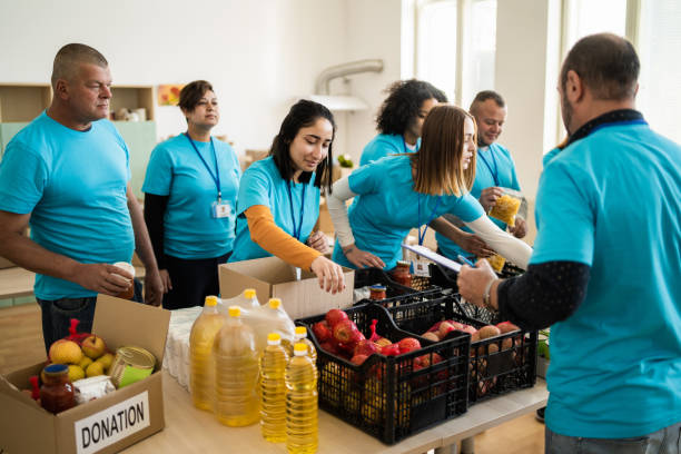 istock Volunteers sort canned food items into crates 2092522146