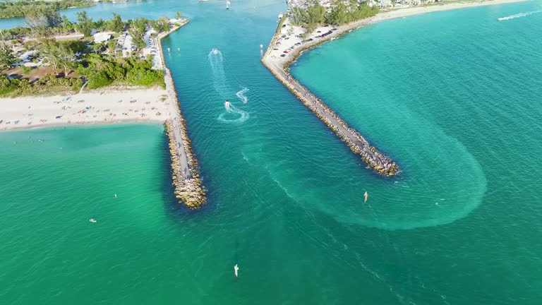 North and South Jetty on Nokomis beach near Venice, Florida. Aerial view of sea shore with white yachts floating on sea waves. Motorboat recreation on ocean surface