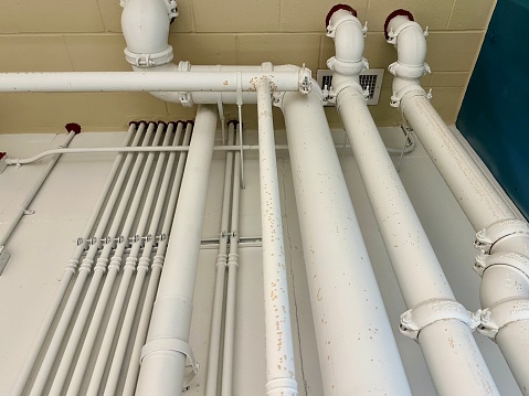 Close-up view of the drainage pipeline connected to the industrial air handling unit