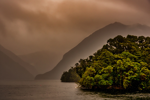 Heavy rain mist and cloud during a storm in Doubtful Sound Fiordland NZ