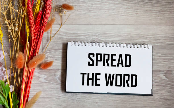 istock A notepad with the inscription Spread the word, on a beautiful background with bright dried flowers. 2092627919