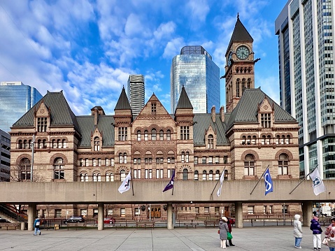 Toronto, Canada - August 16, 2021:  Old City Hall historic stone building and clocktower which houses some Ontario courts was built in 1899