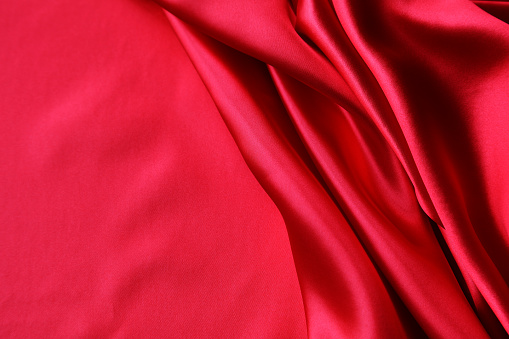 Red short satin bathrobe isolated over white