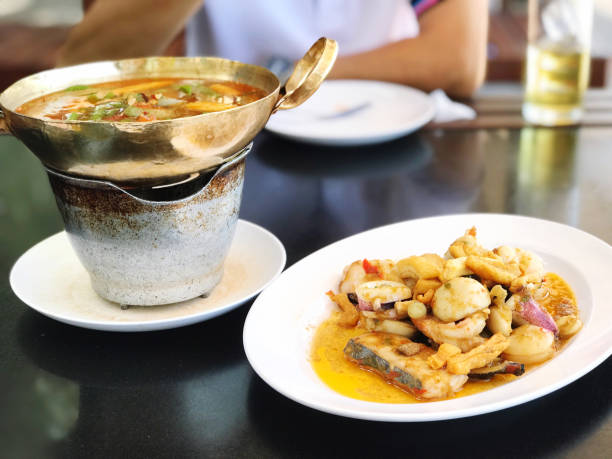 Hot and spicy soup in a pot on the table, Thailand.