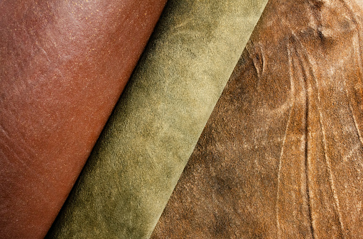 Photo of various colored suede and leather materials laying on table.
