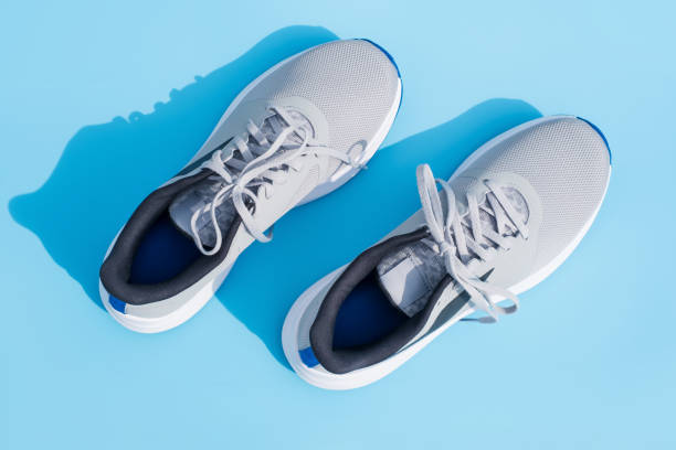 istock Gray sneakers on blue background close-up, top view. 2092802340