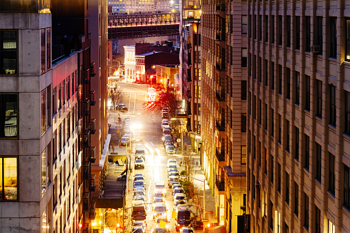 This is a long exposure photograph at night of Front Street at night in downtown Brooklyn shot from a high angle view at rush hour.