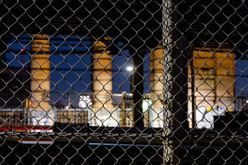 Urban Cityscape Chainlink Fence on Manhattan Bridge at Night