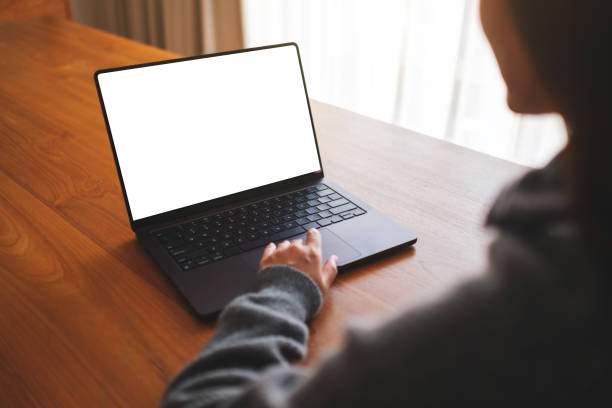 istock Mockup image of a woman working on laptop computer with blank white desktop screen at home 2092884267