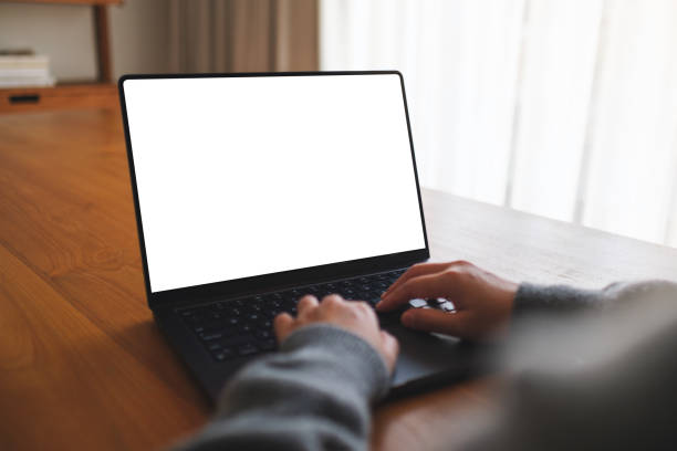 istock Mockup image of a woman working and typing on laptop computer with blank white desktop screen at home 2092885307
