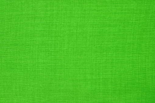 Green lime linen fabric cloth texture for background, natural textile pattern.