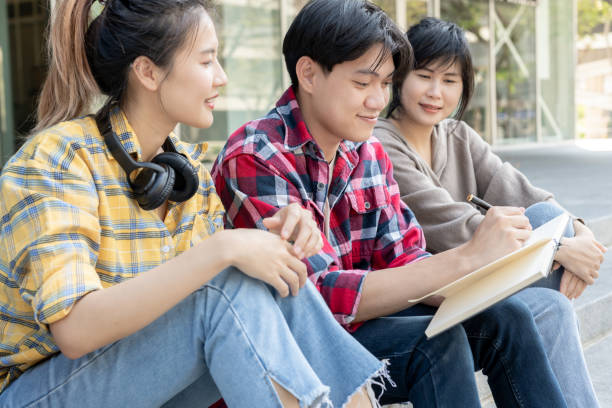 istock Group Asian student meeting team for work project. team happy study online. Read book in college campus. Group on international Asia University. Education, study, school, college, graduation 2092973742