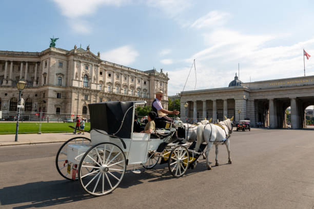 Vienna, Austria - April, 19, 2023: Carriages at the Hofburg Palace in downtown Vienna Austria on a sunny day.