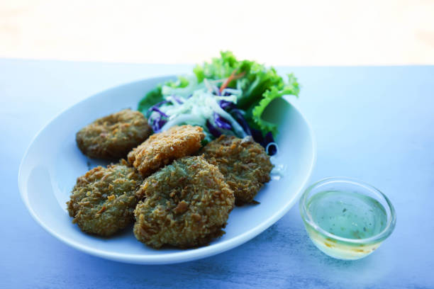 Fried shrimp cakes on a white plate, Thai food.