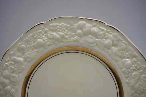 cream and gold colored antique porcelain dinner service set