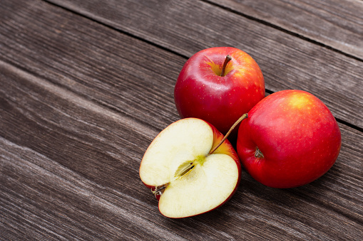 Red apples isolated on wooden table background.