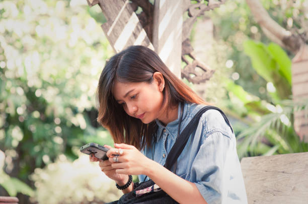 istock Close-up of female hands using modern smart phone while working,Young woman using a touchscreen smartphone 2093084569
