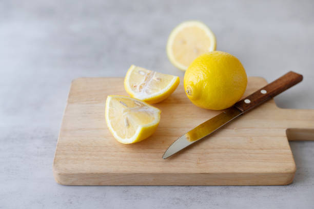 istock Group of yellow lemon slices on a cutting board on a gray table 2093089214