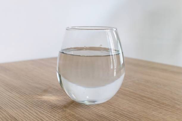 istock A glass of water on wooden table 2093102472
