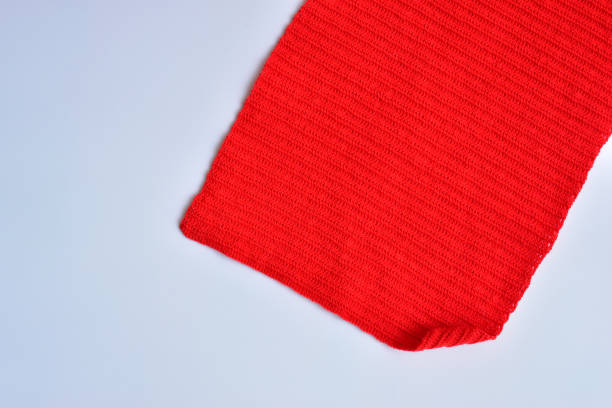 istock red wool knitted yarn texture, woolen fabric on white background 2093112717