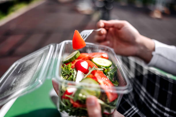 istock Taking a break eating healthy salad in plastic packaging 2093171332