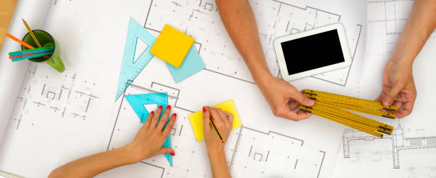 istock Hands drawing a project for a new house 2093215494