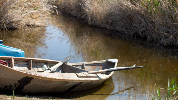 istock a boat in the side of a river 2093220773