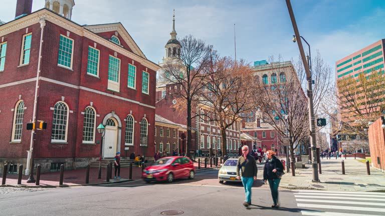 Time lapse of Independence Hall Philadelphia's landmark historic with traffic car and crowd pedestrian tourist crossroad city street in Pennsylvania, Philadelphia, United States