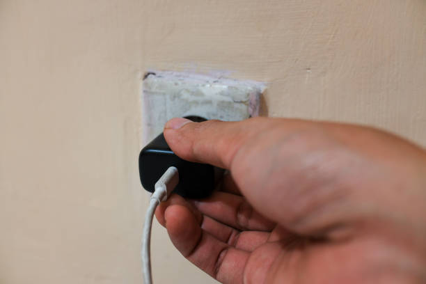 istock The hand that is plugging the cellphone charge into the socket 2093237221
