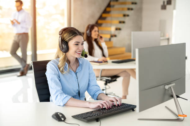istock Service desk operator woman with headset answering client's questions and resolving client's issues in call center. 2093237473