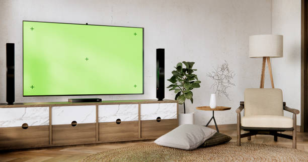 istock Smart Tv Mockup with blank green screen hanging in modern white empty room interior minimal designs. 2093243819