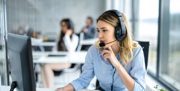 istock Pensive female helpdesk service agent working on computer at call center. 2093248680