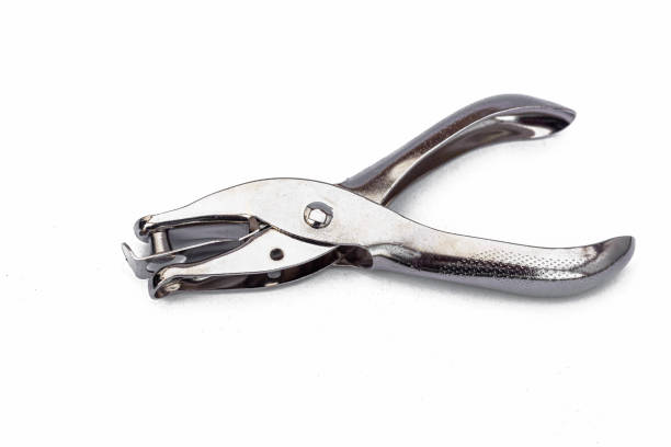 Macro detail of a set of steel punches isolated on white background