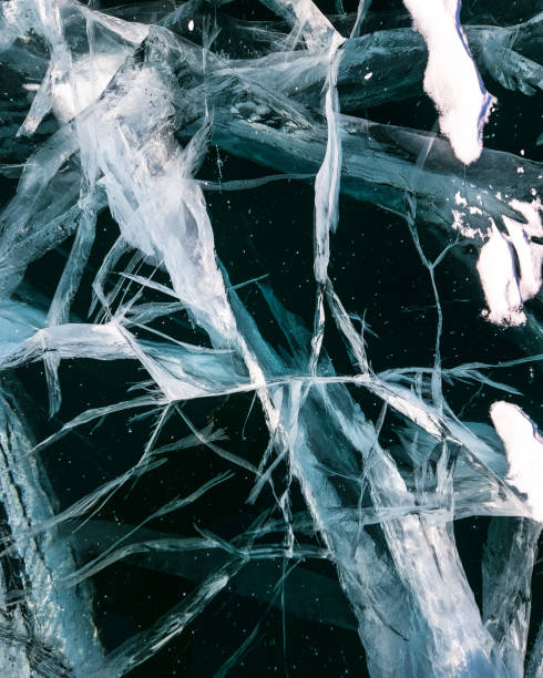 istock Cracked ice on a frozen lake, view from the top. Mouse background. 2093266198