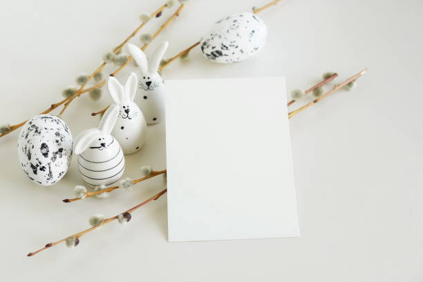 istock Easter background.Card mockup, empty blank paper,Easter eggs and funny bunny decor ,spring willow branches in neutral colors on white background top view flatlay. Copy space.Aesthetic minimal . 2093271116