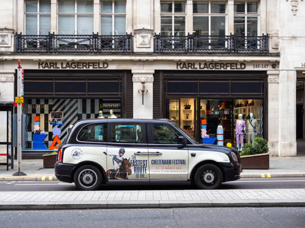 Karl Lagerfeld stor on the Regent Street in London London, United Kingdom - February 26, 2024: London taxi in front of the Karl Lagerfeld fashion store karl lagerfeld stock pictures, royalty-free photos & images