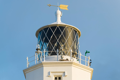 Close-up of lighthouse tower and lamp at the southernmost cape of Great Britain Lizard Point, Cornwall, England at sunrise