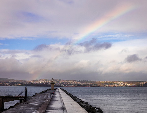 Views of Brixham breakwater and rainbows out in Torbay Devon west England UK