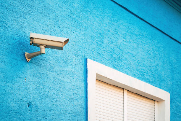 istock Security surveillance camera equipment mounted on blue house wall 2093333200