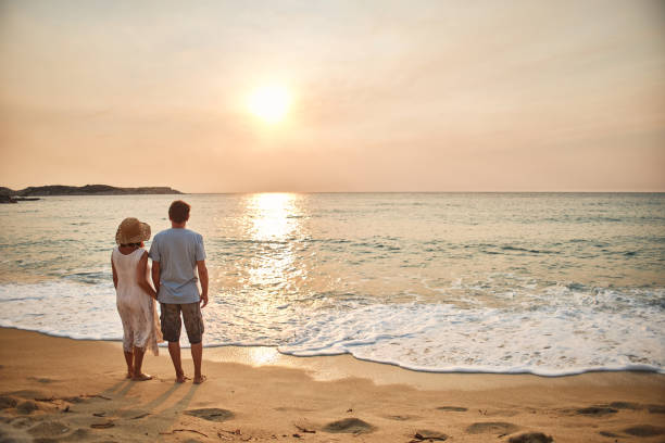 istock Senior couple enjoying walking along the beach 2093348642