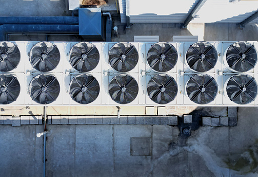 The cooling units are industrial or air-conditioning, which are used in the summer for cooling the premises, with fans on the roof of the storage hall, mainly for industrial operations, high angle, conditioning, effective,