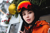Portrait of a woman in the Alps. Young beautiful caucasian woman in ski goggles looking at the camera with a sexy look
