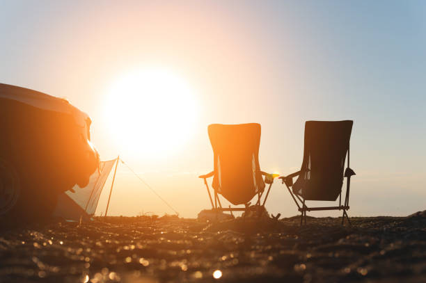 istock Two empty picnic chairs, next to a car, outdoors. place for camping and weekend getaway 2093359254