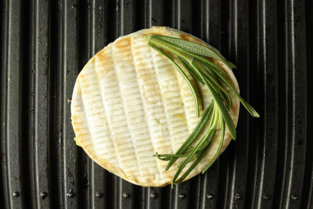 Grilled camembert on electric grill, close up.